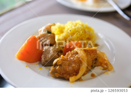 Plate, food, vegetables rice meat carrots Asian traditional culinary dish pilaf holding kitchen spoon. Ingredients rice, meat, vegetables carrot, onion spices and fat. National Eastern tasty food 126593053