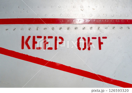Keep Off warning sign on the fuselage of an old aircraft Keep Off warning sign on the fuselage of an old aircraft 126593320