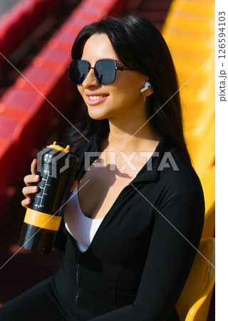 Woman Holding Sports Bottle On Stands Woman Holding Sports Bottle On Stands 126594103