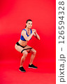 Athletic female performs exercises using a resistance band. Strength and motivation 126594328