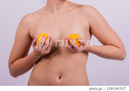 Naked woman back with an orange fruit the isolated image Naked woman back with an orange fruit the isolated image 126594337