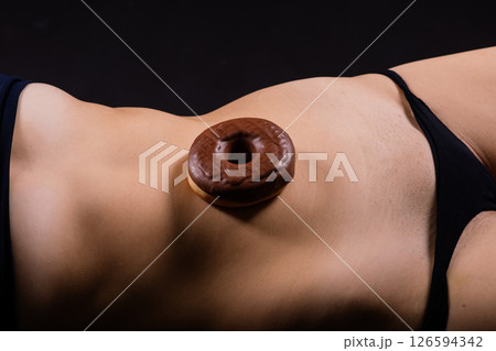 Close up young nice lady woman with slim body perfect skin nude top bra lingerie stand hold donut 126594342