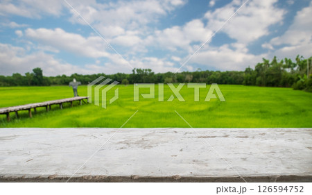 empty cement old table on blur rice field and cloud background, for your product placement or montage with focus to the table top in the foreground. blank shelf, shelves with copy space 126594752