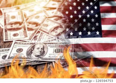 US dollar bank note currency and USA flag burn on fire. the economic crisis in the United States and investors' confidence in the value of the American dollar concept. US dollar bank note currency and USA flag burn on fire. the economic crisis in the United States and investors' confidence in the value of the American dollar concept. 126594753