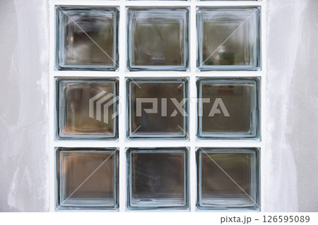 Clear glass block and concrete wall. 126595089