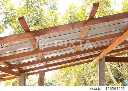 Roof under construction with metal sheet and wood structure. Roof under construction with metal sheet and wood structure. 126595093