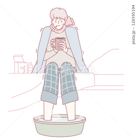 Enjoy cozy winter relaxation with a soothing foot soak and a warm drink for comfort 126595194