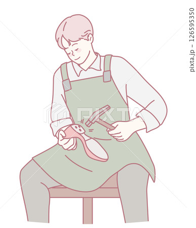 A skilled craftsman working diligently to meticulously repair a shoe with care and precision 126595350