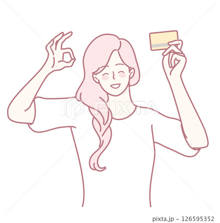 A delighted woman is joyfully holding her credit card, radiating positivity and style 126595352