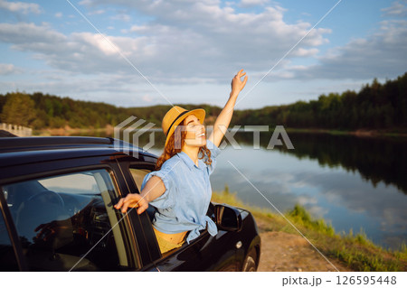 Towards adventure! Young woman is resting and enjoying trip in car. Lifestyle, travel, active life. Towards adventure! Young woman is resting and enjoying trip in car. Lifestyle, travel, active life. 126595448