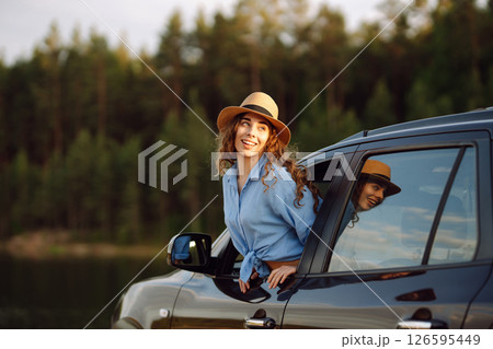 Towards adventure! Young woman is resting and enjoying trip in car. Lifestyle, travel, active life. Towards adventure! Young woman is resting and enjoying trip in car. Lifestyle, travel, active life. 126595449