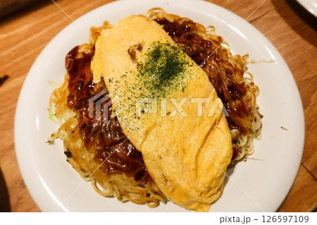 close up of Japanese Hiroshima style egg omelette with pan fried noodles (Hiroshima Style Okonomiyaki) close up of Japanese Hiroshima style egg omelette with pan fried noodles (Hiroshima Style Okonomiyaki) 126597109