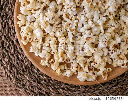 Butter salted popcorn on wooden table. Butter salted popcorn on wooden table. 126597584