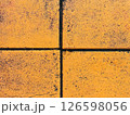 Close-up of yellow concrete tiles with black grout lines 126598056