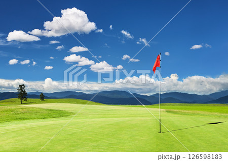 Golf field with a red flag Golf field with a red flag 126598183