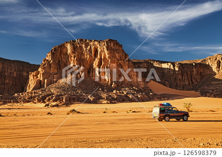 Car drives in Sahara Desert in Algeria Car drives in Sahara Desert in Algeria 126598379