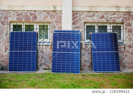 Stack of new solar panels with protective cardboard, ready for installation. Renewable energy, sustainable home improvements, and eco-friendly investments in residential property infrastructure. Stack of new solar panels with protective cardboard, ready for installation. Renewable energy, sustainable home improvements, and eco-friendly investments in residential property infrastructure. 126599422