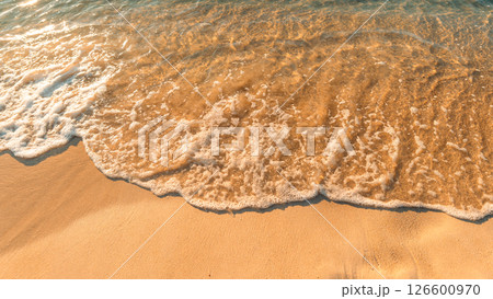 Sand on the beach and sea waves in the morning, orange tone. Sand on the beach and sea waves in the morning, orange tone. 126600970