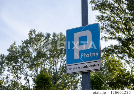 Blue urban parking sign with white P symbol text Paid Payment at parking meter provides clear instruction for paid parking area use 126601250