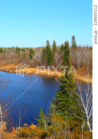 river among coniferous forest and rocks, northern nature 126605112