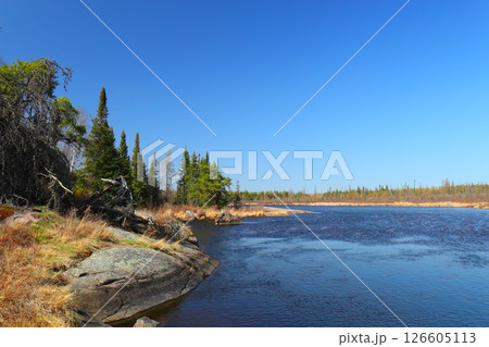 river among coniferous forest and rocks, northern nature 126605113