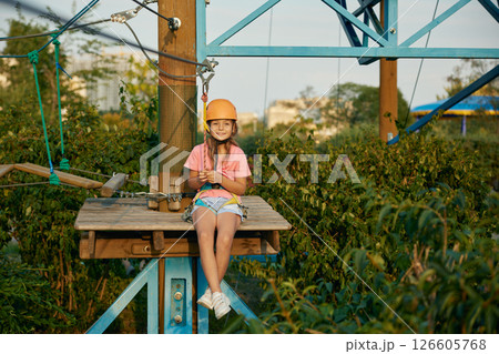 Climber child feeling satisfaction from adventure in rope park Climber child feeling satisfaction from adventure in rope park 126605768