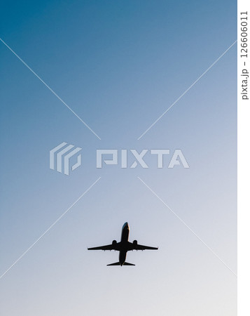 Jet plane soaring high against a clear blue sky, showcasing the beauty of modern air travel and the boundless expanse of the atmosphere, embodying freedom and adventure. limitless aerial exploration Jet plane soaring high against a clear blue sky, showcasing the beauty of modern air travel and the boundless expanse of the atmosphere, embodying freedom and adventure. limitless aerial exploration 126606011
