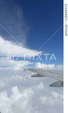 vertical photos Airplane wing clouds Wing of the plane on blue sky background vertical photos Airplane wing clouds Wing of the plane on blue sky background 126606372