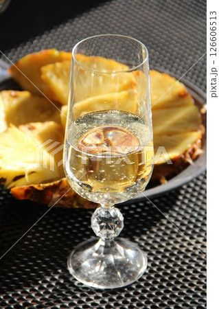Bridal Shower. A glass of champagne with pineapple pieces 126606513