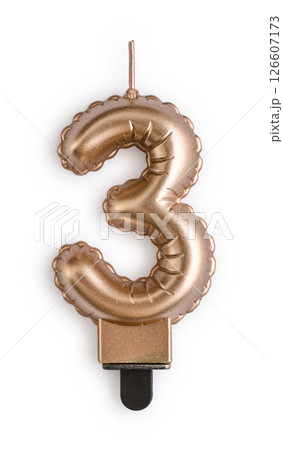 Golden  cake candle in shape of number three 126607173