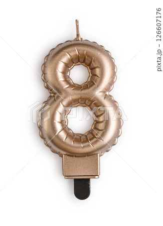 Golden cake candle in shape of number eight Golden cake candle in shape of number eight 126607176