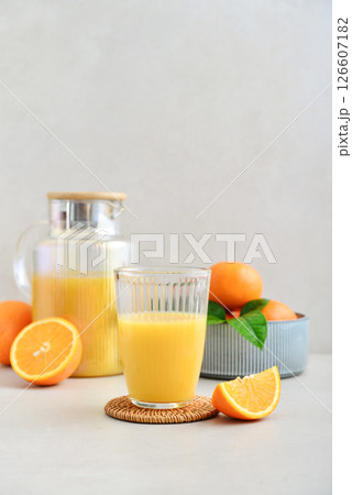 Orange fresh squeezed juice in glass and glasses jug Orange fresh squeezed juice in glass and glasses jug 126607182