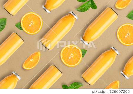 Pattern from bottles of orange juice and orange slices Pattern from bottles of orange juice and orange slices 126607206