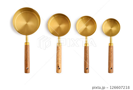 Golden measuring spoons with wooden handles 126607218