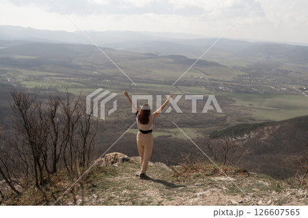 Mountains Woman Nature: Woman celebrates mountain top view during daytime, feeling freedom, happiness. Mountains Woman Nature: Woman celebrates mountain top view during daytime, feeling freedom, happiness. 126607565