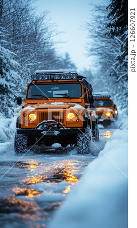 Bold winter scene with three trucks forging through icy riverbanks under thick snow, their tires gripping frost and steel strength pushing through harsh wilderness 126607921