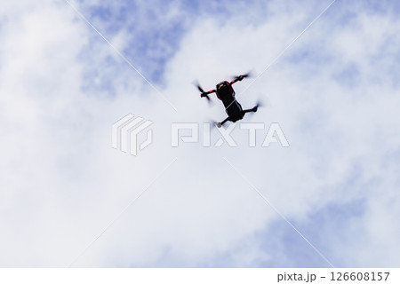 Drone flying over sky background 126608157