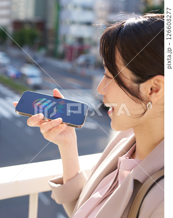 屋外で音声アシスタントと会話する女性 屋外で音声アシスタントと会話する女性 126608277