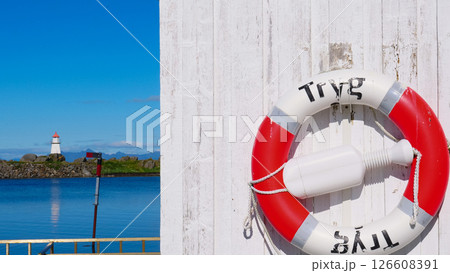 Rescue ring and lighthouse, Hovsund Lofoten Norway Rescue ring and lighthouse, Hovsund Lofoten Norway 126608391