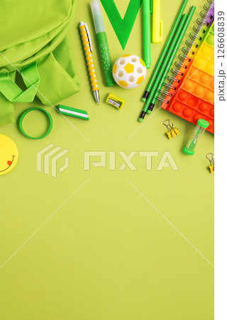 Back to school concept. Border made of school supplies on green background. Top view. Copy space 126608839