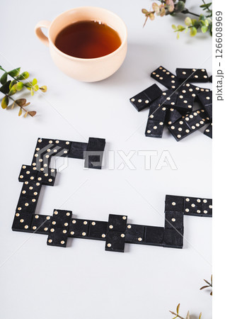 Traditional black dotted dominoes for table game vertical view Traditional black dotted dominoes for table game vertical view 126608969