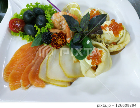 A delicious fish platter on a large white plate A delicious fish platter on a large white plate 126609294