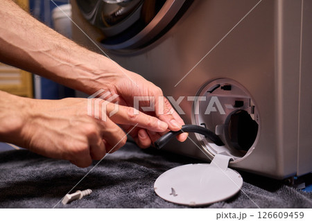 Repairing a Washing Machine Hose Connection at Home Requires Handy Skills and Tools Repairing a Washing Machine Hose Connection at Home Requires Handy Skills and Tools 126609459