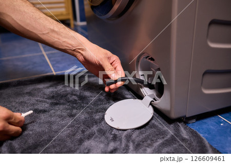 Repairing a Washing Machine Hose Connection at Home Requires Handy Skills and Tools 126609461