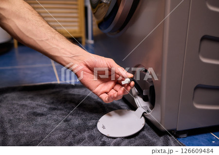 Repairing a Washing Machine Hose Connection at Home Requires Handy Skills and Tools 126609484