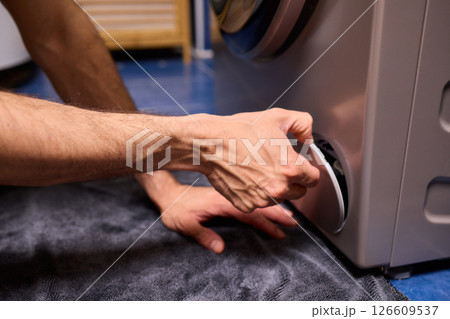 Repairing a Washing Machine Hose Connection at Home Requires Handy Skills and Tools 126609537