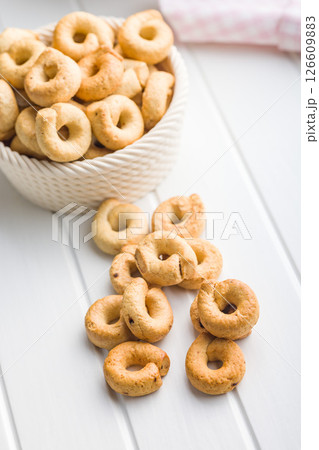 Salted crispy snack rings on kitchen table. Salted crispy snack rings on kitchen table. 126609883