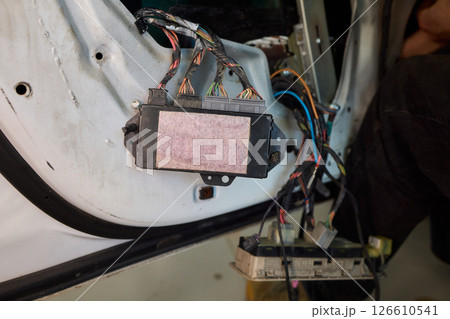 Automotive Repair Skilled Hands Working on Car Wiring for Efficient Performance and Safety Automotive Repair Skilled Hands Working on Car Wiring for Efficient Performance and Safety 126610541