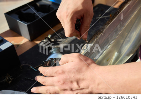 Hands actively engaged in working on advanced technology with various modern gadgets and devices 126610543