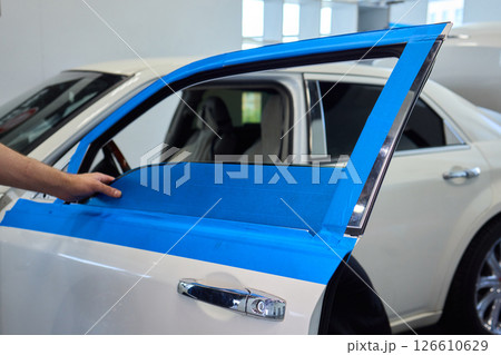 Hands Engaged in the Process of Performing Automotive Interior Repairs Effectively Hands Engaged in the Process of Performing Automotive Interior Repairs Effectively 126610629